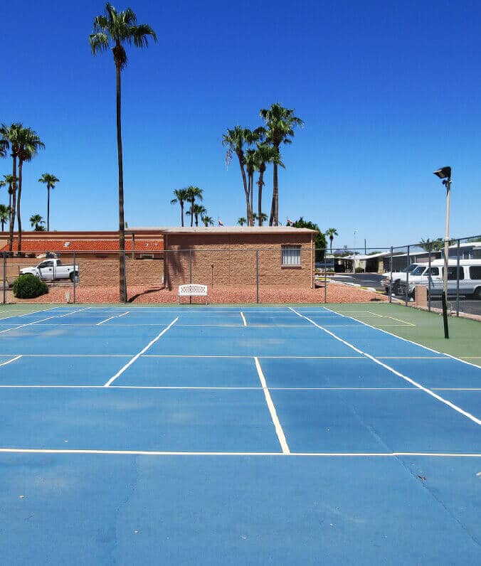 Outdoor badminton court on a fenced area under the clear sky near Apache Junction, Arizona.